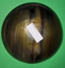 Polished buffalo horn bowl measuring 7" wide by 2 to 2-1/4" deep.