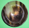 Polished buffalo horn bowl measuring 5" wide by 1 7/8" deep.