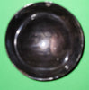 Polished buffalo horn bowl measuring 4" wide by 1 5/8" deep.