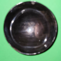 Polished buffalo horn bowl measuring 4" wide by 1 5/8" deep.