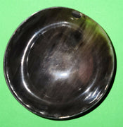 Polished buffalo horn bowl measuring 4" wide by 1 5/8" deep.