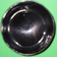Polished buffalo horn bowl measuring 4" wide by 1 5/8" deep.