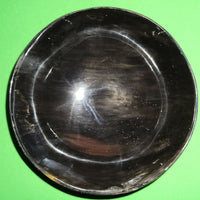 Polished buffalo horn bowl measuring 5" wide by 1 7/8" deep.