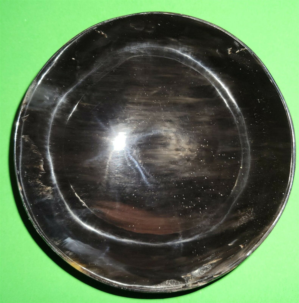 Polished buffalo horn bowl measuring 5" wide by 1 7/8" deep.