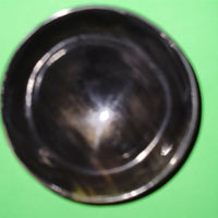 Polished buffalo horn bowl measuring 4" wide by 1 5/8" deep.