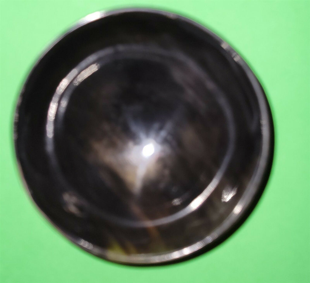 Polished buffalo horn bowl measuring 4" wide by 1 5/8" deep.