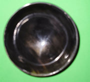 Polished buffalo horn bowl measuring 4" wide by 1 5/8" deep.