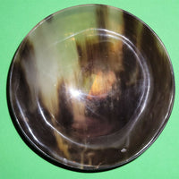 Polished buffalo horn bowl measuring 5" wide by 1 7/8" deep.