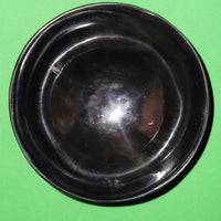 Polished buffalo horn bowl measuring 4" wide by 1 5/8" deep.