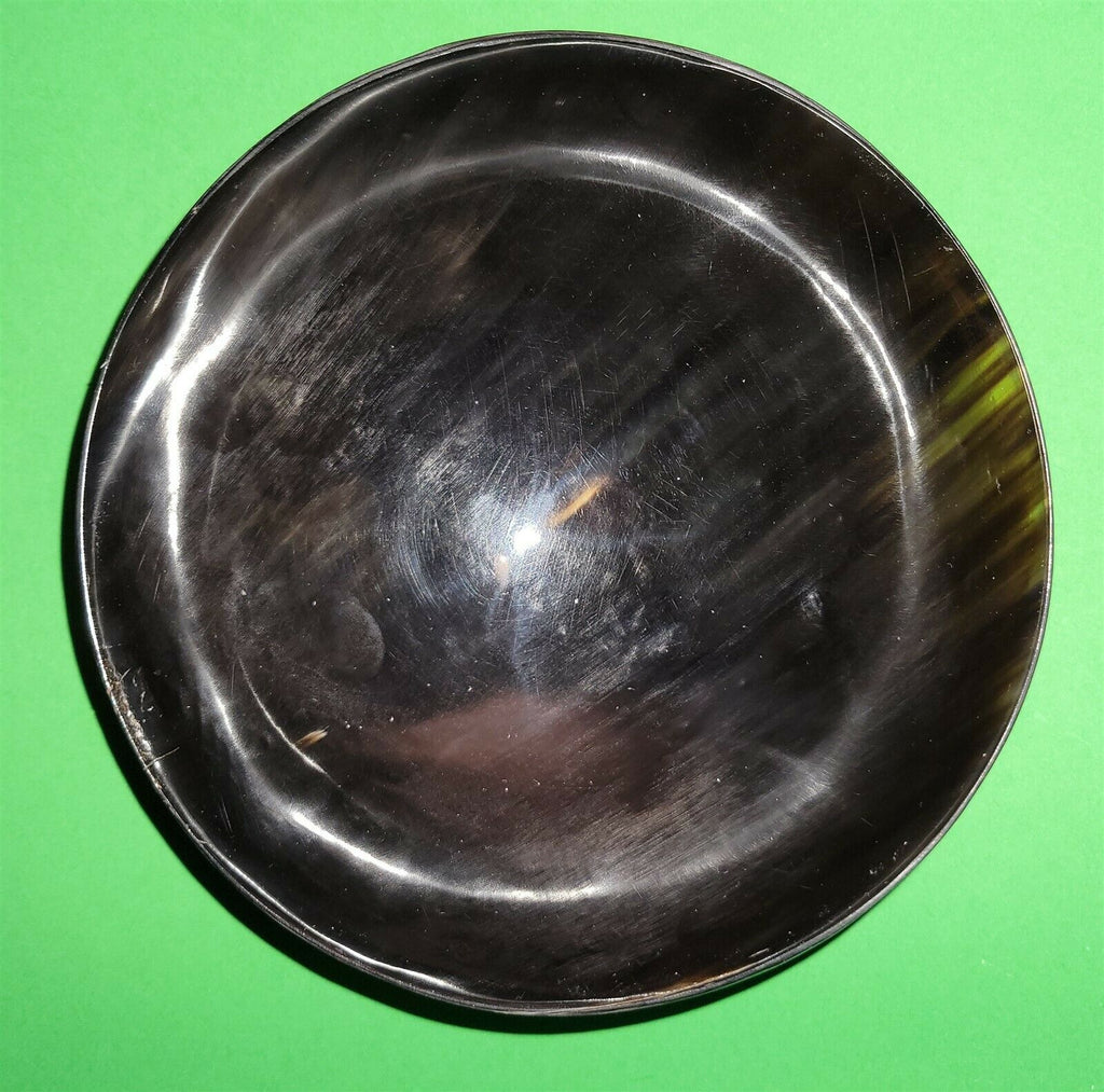 Polished buffalo horn bowl measuring 6" wide by 1 7/8" deep.