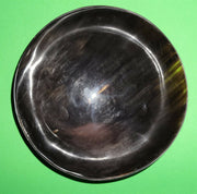 Polished buffalo horn bowl measuring 6" wide by 1 7/8" deep.