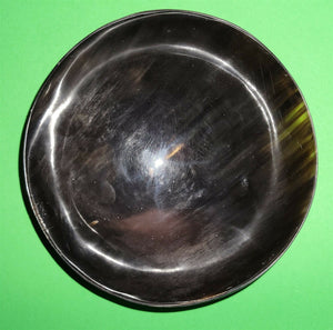 Polished buffalo horn bowl measuring 6" wide by 1 7/8" deep.