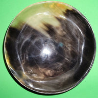 Polished buffalo horn bowl measuring 6" wide by 1 7/8" deep.