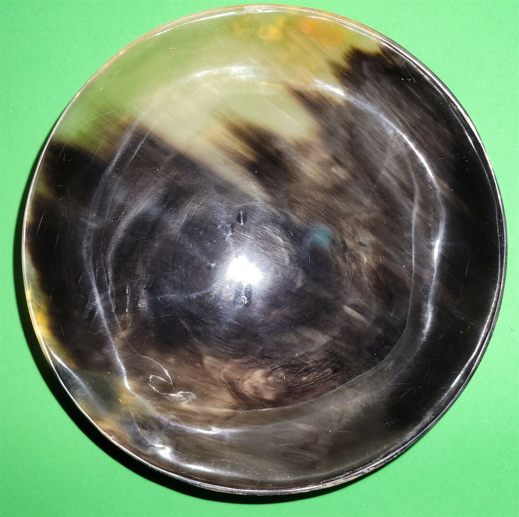 Polished buffalo horn bowl measuring 6" wide by 1 7/8" deep.