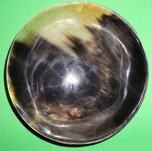Polished buffalo horn bowl measuring 6" wide by 1 7/8" deep.