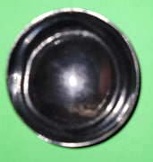 Polished buffalo horn bowl measuring 4" wide by 1 5/8" deep.