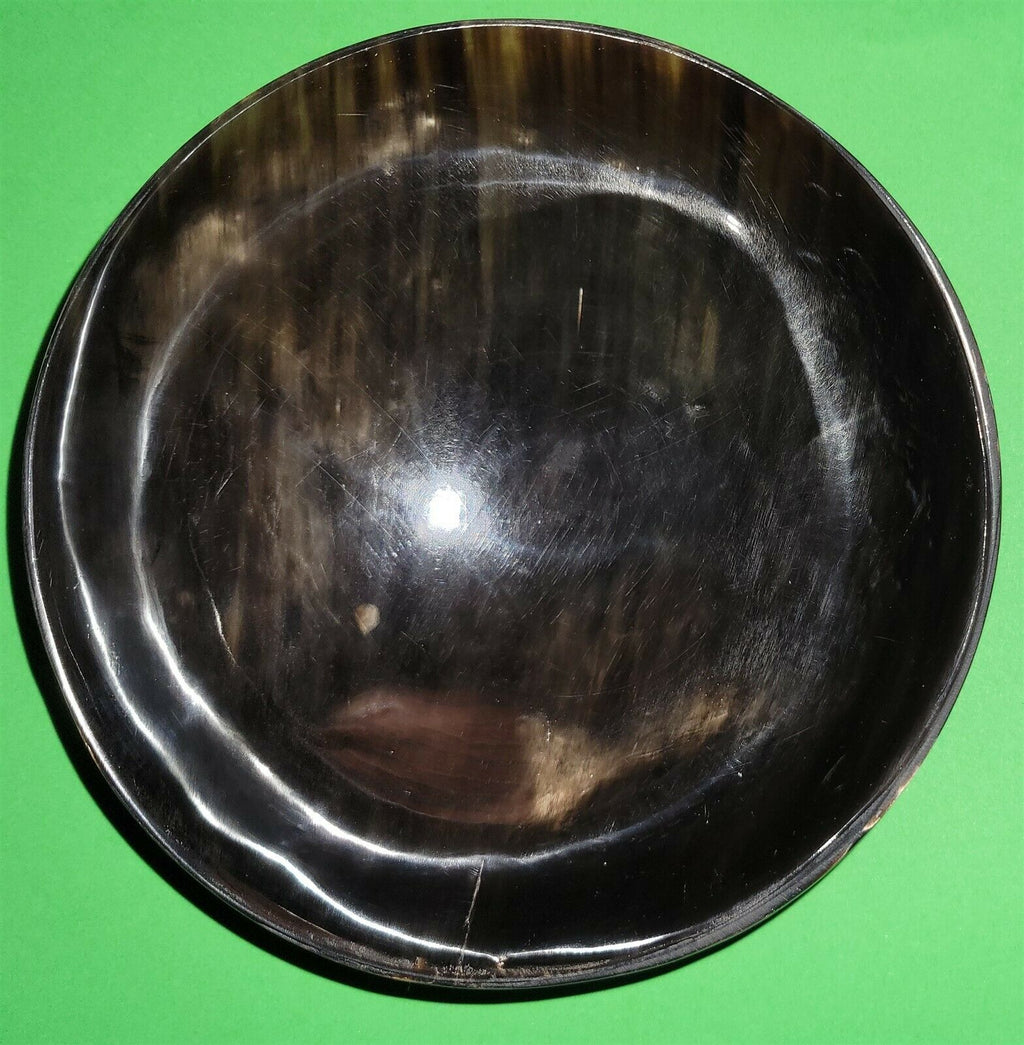Polished buffalo horn bowl measuring 6" wide by 1 7/8" deep.