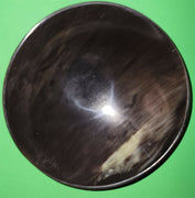 Polished buffalo horn bowl measuring 7" wide by 2 to 2-1/4" deep.