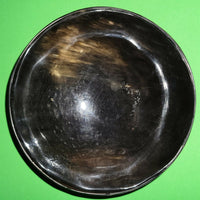 Polished buffalo horn bowl measuring 6" wide by 1 7/8" deep.