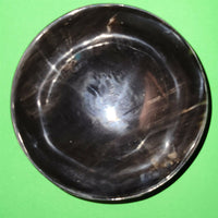 Polished buffalo horn bowl measuring 5" wide by 1 7/8" deep.