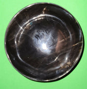 Polished buffalo horn bowl measuring 5" wide by 1 7/8" deep.