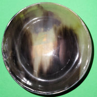 Polished buffalo horn bowl measuring 4" wide by 1 5/8" deep.