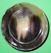 Polished buffalo horn bowl measuring 4" wide by 1 5/8" deep.