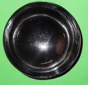 Polished buffalo horn bowl measuring 4" wide by 1 5/8" deep.