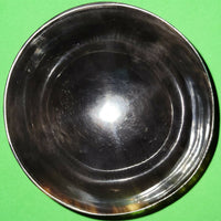 Polished buffalo horn bowl measuring 4" wide by 1 5/8" deep.