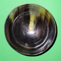 Polished buffalo horn bowl measuring 4" wide by 1 5/8" deep.