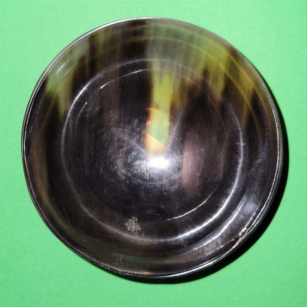 Polished buffalo horn bowl measuring 4" wide by 1 5/8" deep.