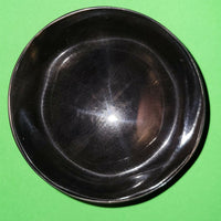 Polished buffalo horn bowl measuring 4" wide by 1 5/8" deep.