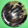 Polished buffalo horn bowl measuring 6" wide by 1 7/8" deep.