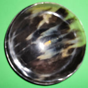 Polished buffalo horn bowl measuring 6" wide by 1 7/8" deep.